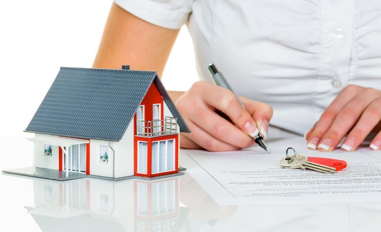 Kobieta podpisuje umowę kupna domu z agentem nieruchomości.